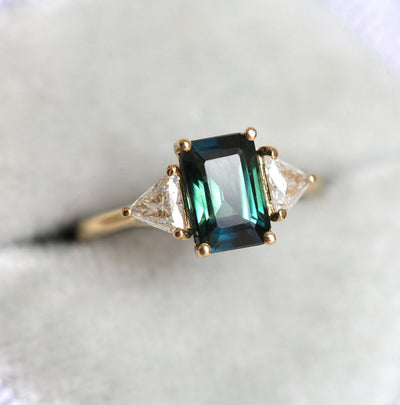 Emerald-cut teal sapphire ring with white diamonds