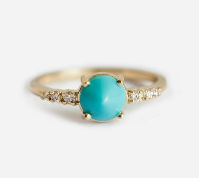 Round blue turquoise ring with white side diamonds