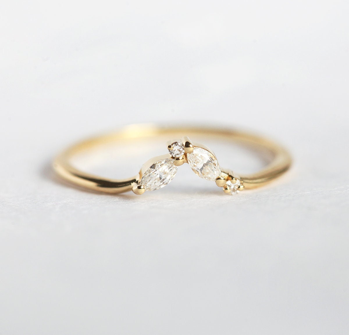Oval-shaped white diamond curved wedding band