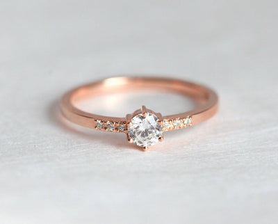 Round diamond engagement ring with side diamonds