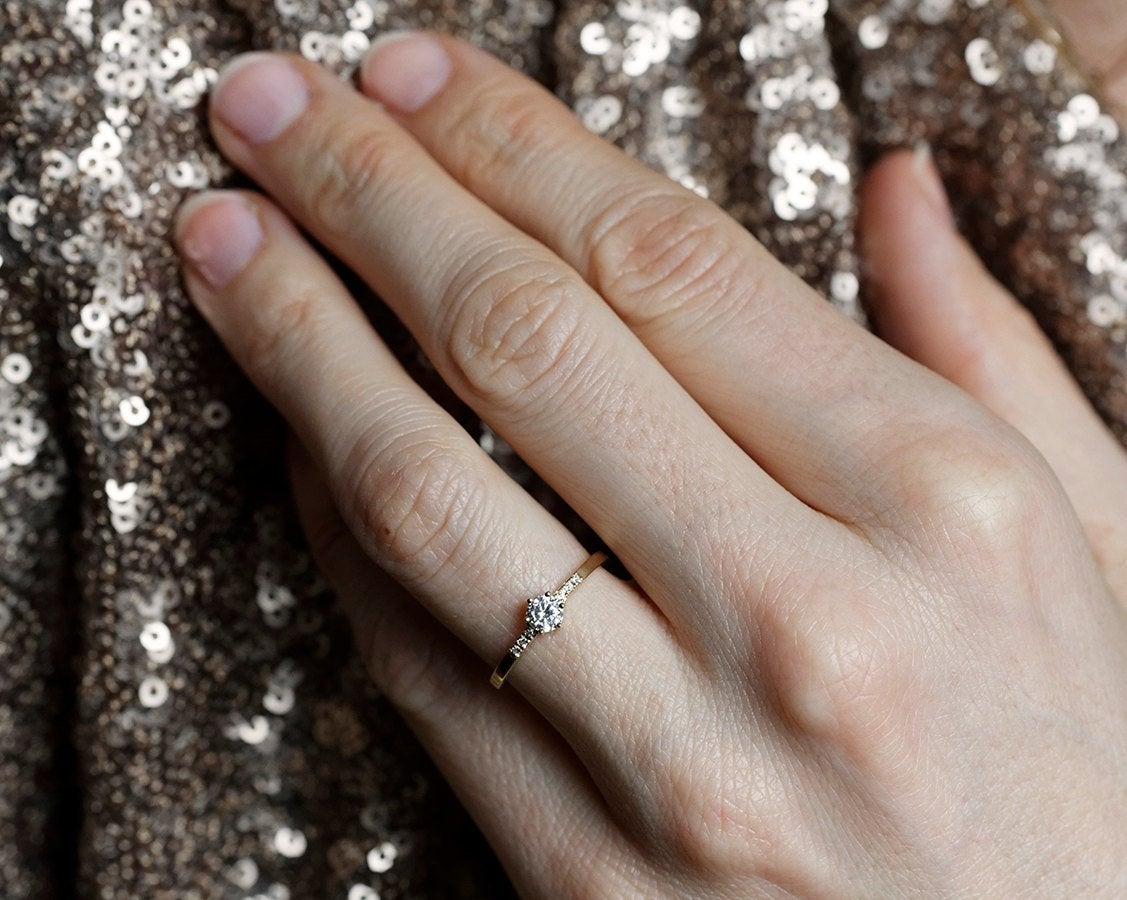 Round diamond engagement ring with side diamonds