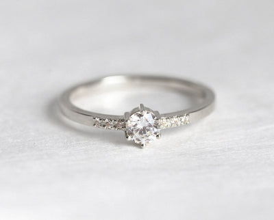 Round diamond engagement ring with side diamonds