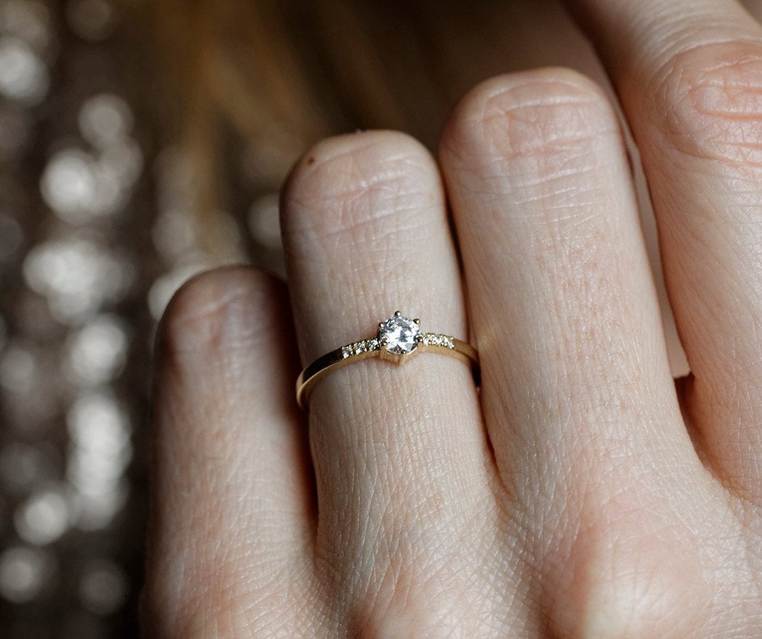 Round diamond engagement ring with side diamonds