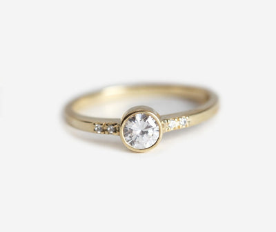 Round white diamond engagement ring with side diamonds