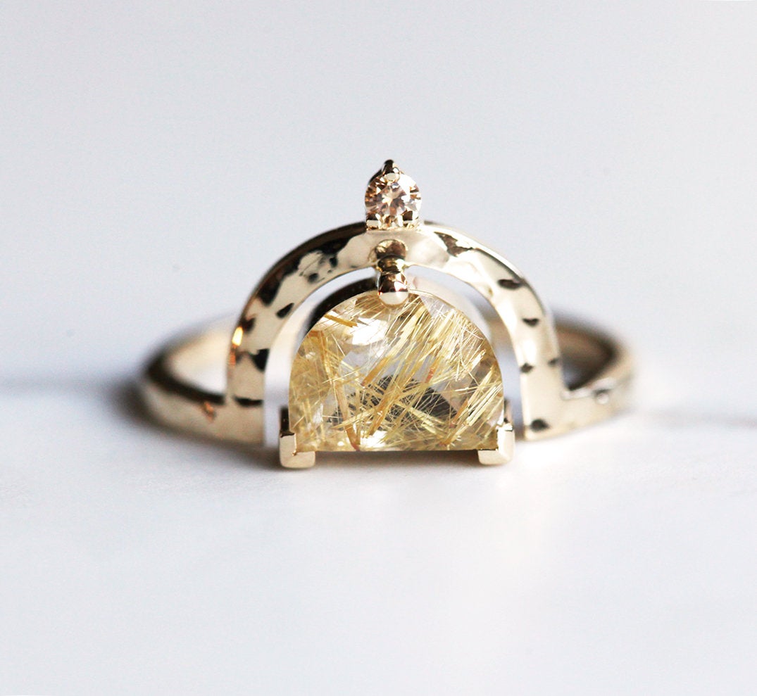 Half-moon-shaped golden rutile quartz ring with champagne diamond