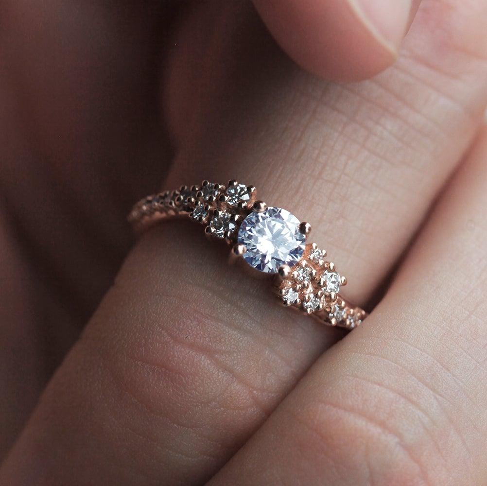 Round white moissanite ring with white diamond cluster