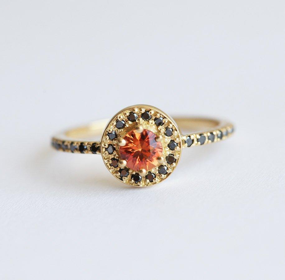 Round orange sapphire eternity ring with black diamonds
