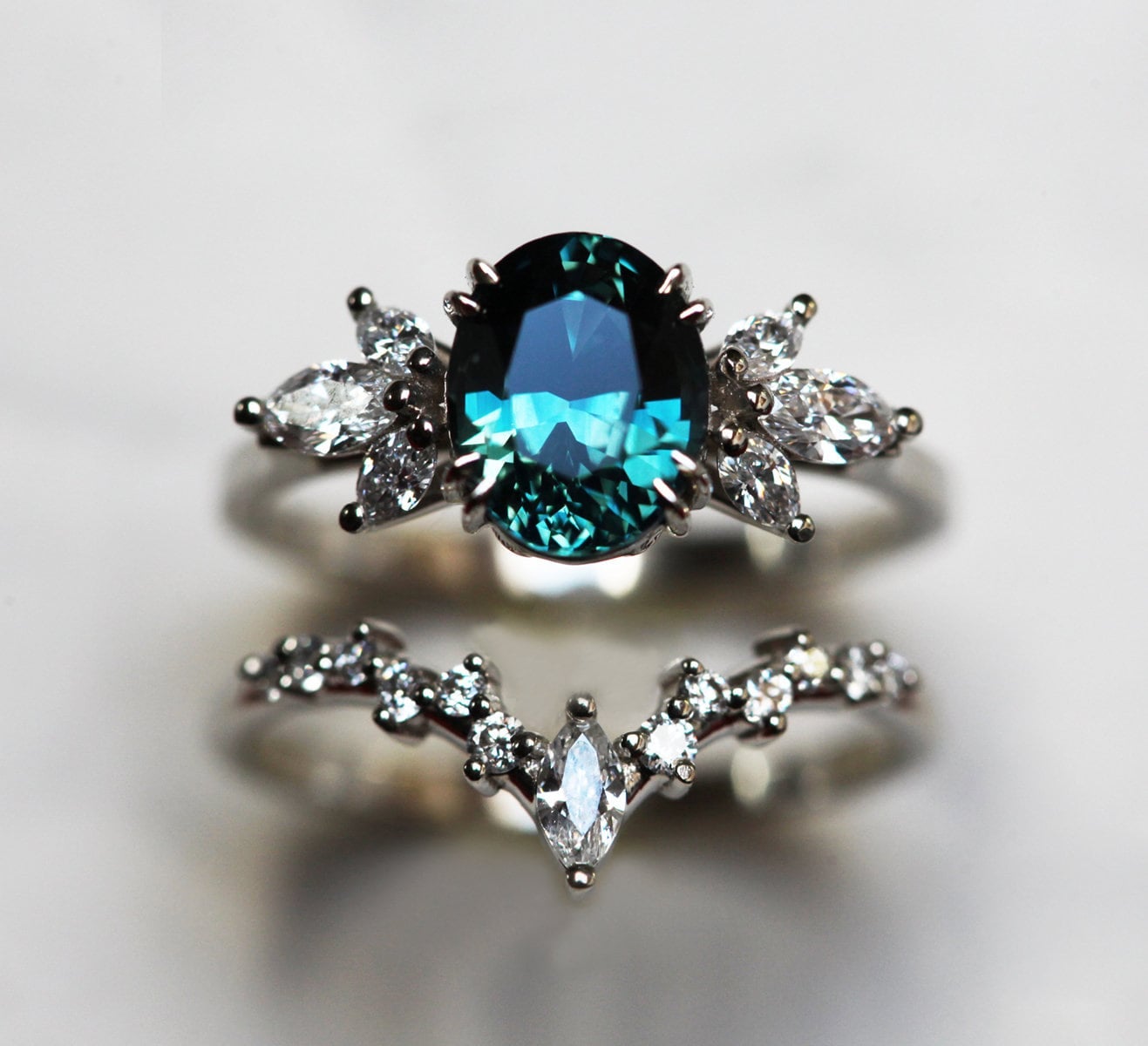 Oval-shaped black opal and white diamond ring set