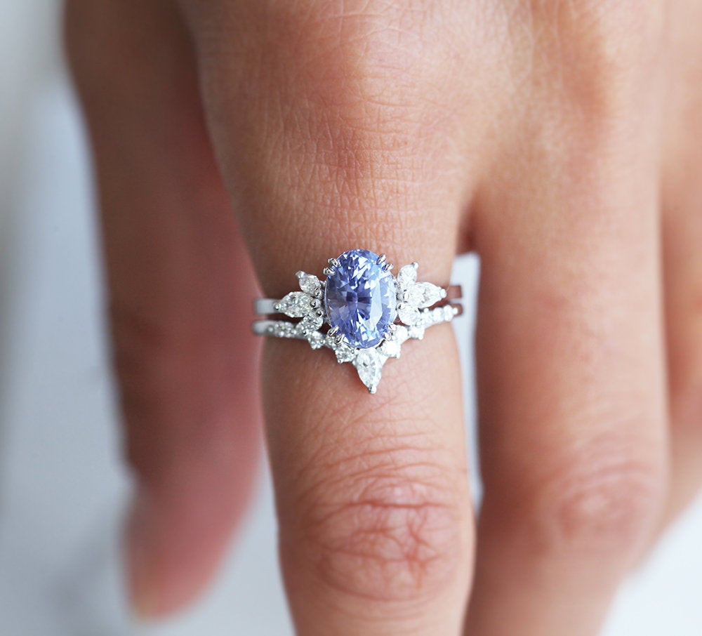Oval-shaped lavender sapphire ring and marquise-cut white diamond band