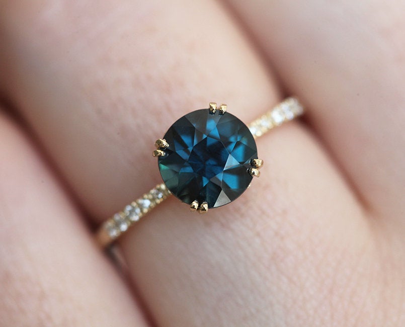 Round teal sapphire ring with white diamonds