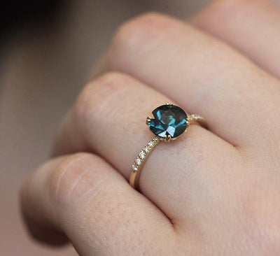 Round teal sapphire ring with white diamonds