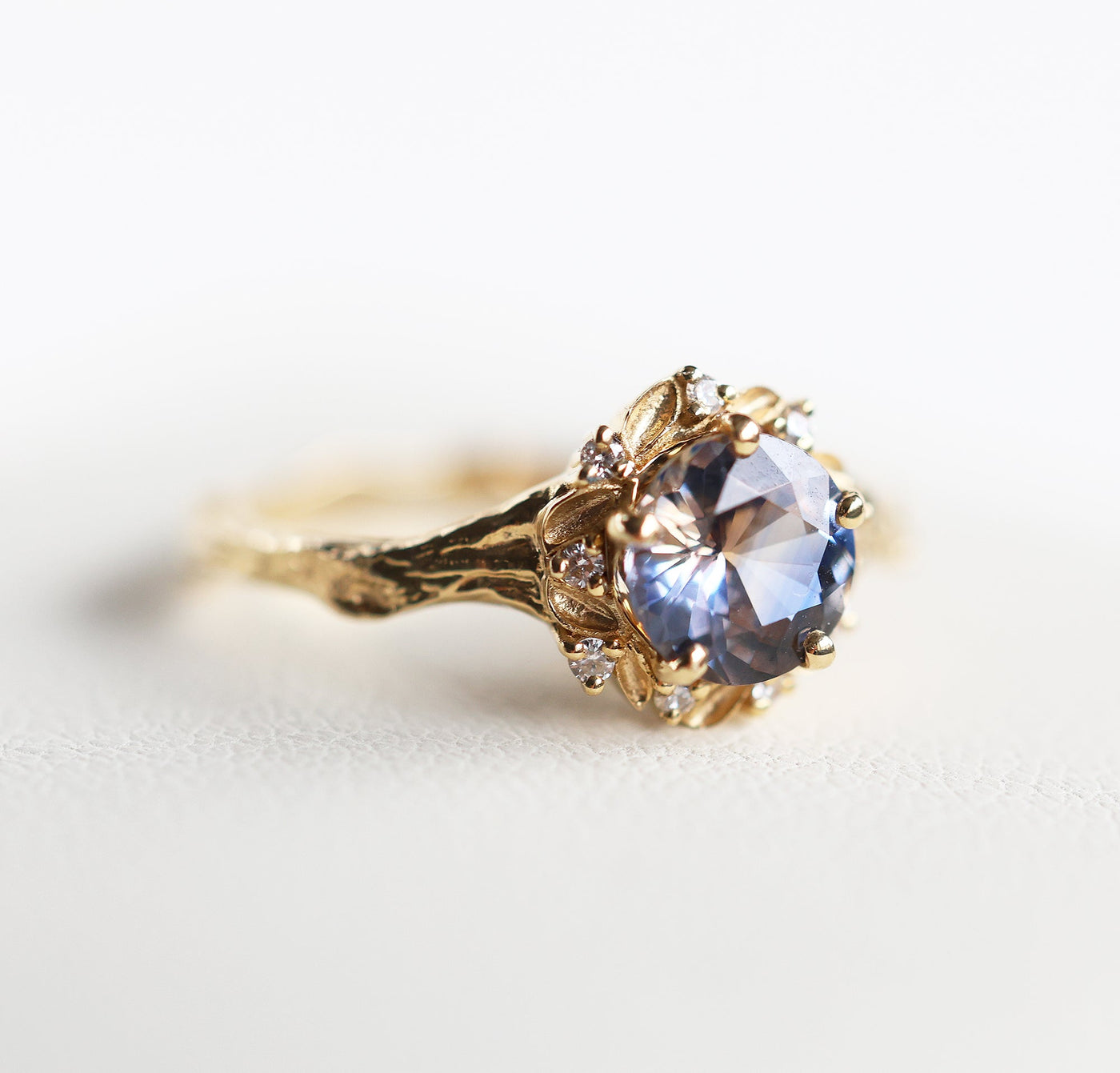 Whimsical round bicolor sapphire engagement ring