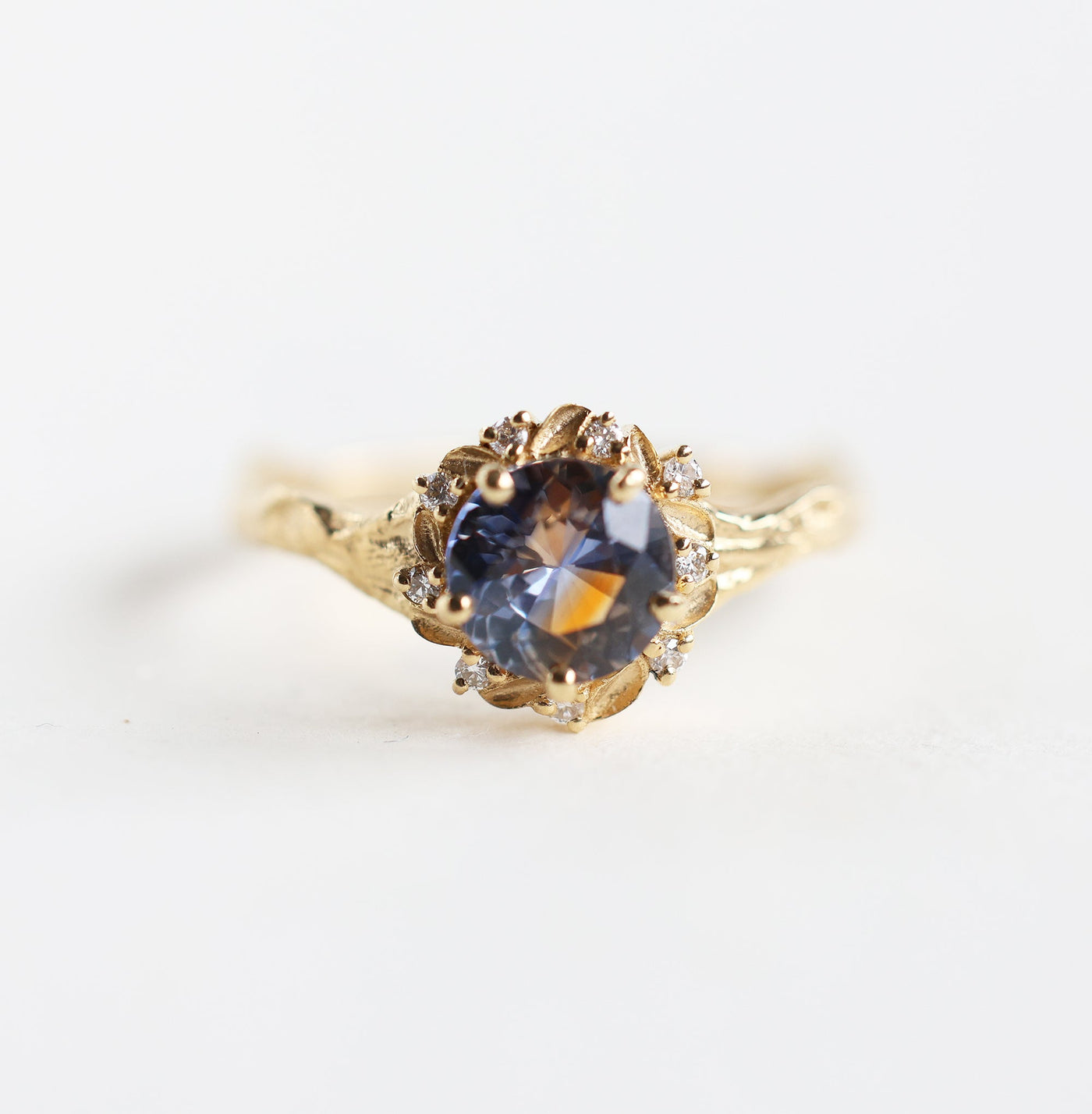 Whimsical round bicolor sapphire engagement ring