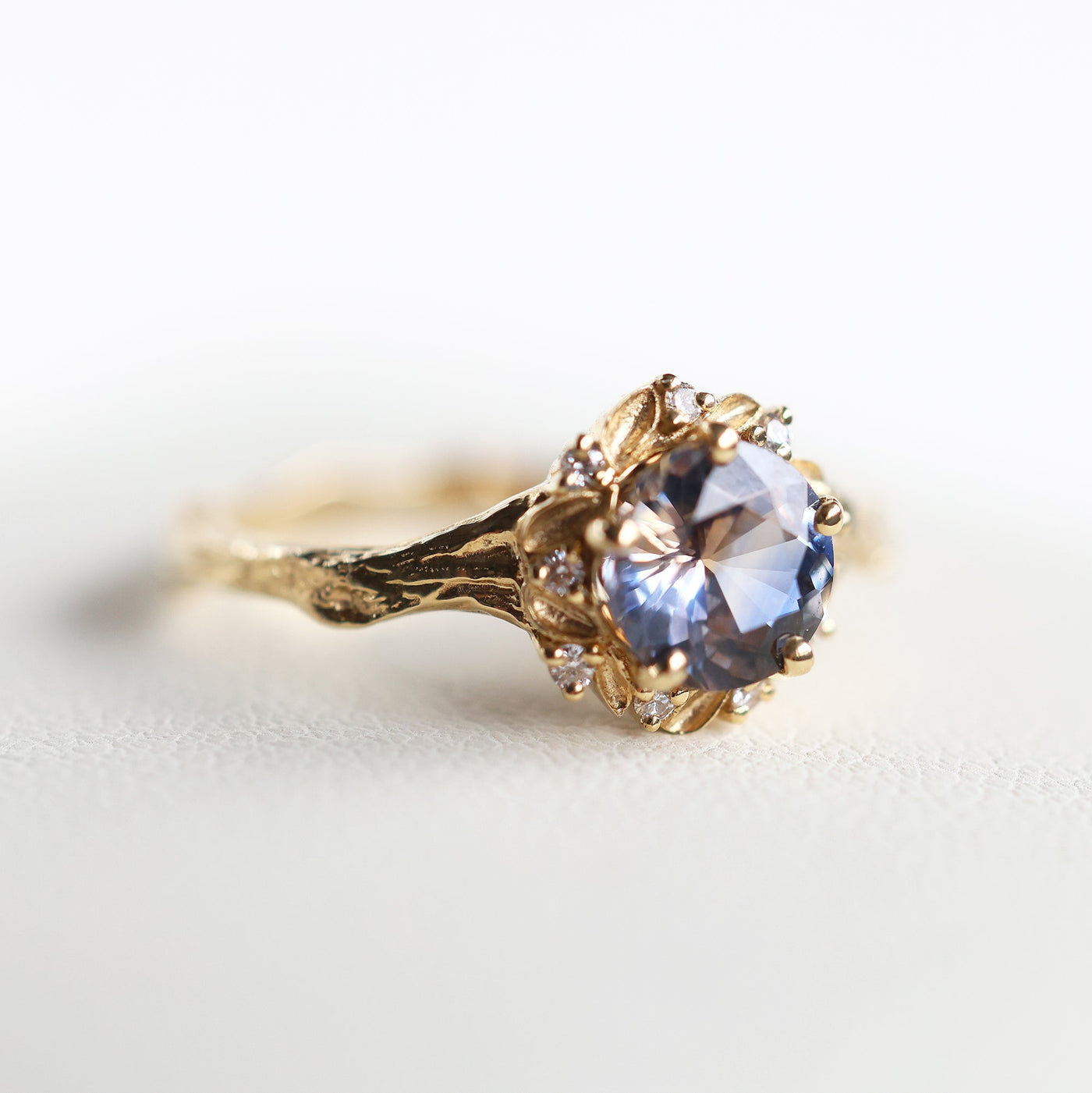 Whimsical round bicolor sapphire engagement ring