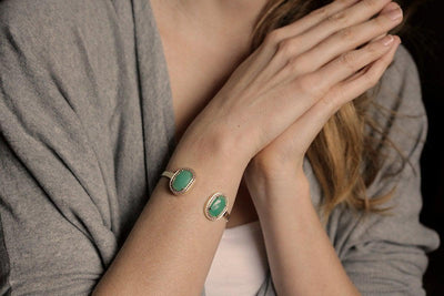 Wide cuff gold bracelet with oval green chrysoprase gems and ruby halos