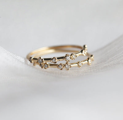 Yellow gold diamond ring with an elegant and modern curved design.