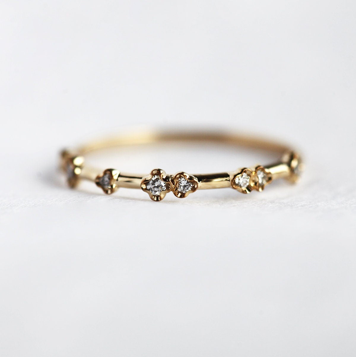 Stylish yellow gold diamond ring with a unique curved band.