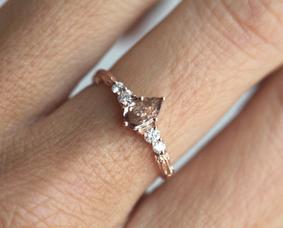 Pear-shaped peach champagne diamond ring with white side diamonds