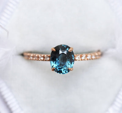 Oval-shaped blue sapphire ring with white diamonds