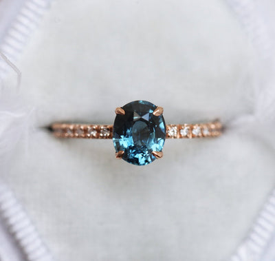 Oval-shaped blue sapphire ring with white diamonds