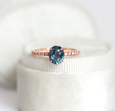 Oval-shaped blue sapphire ring with white diamonds