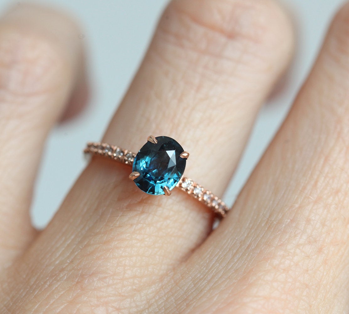 Oval-shaped blue sapphire ring with white diamonds