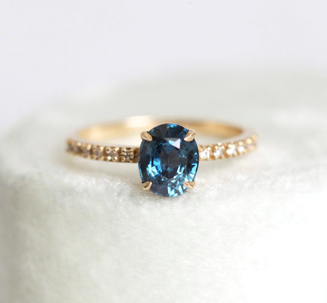 Oval-shaped blue sapphire ring with white diamonds