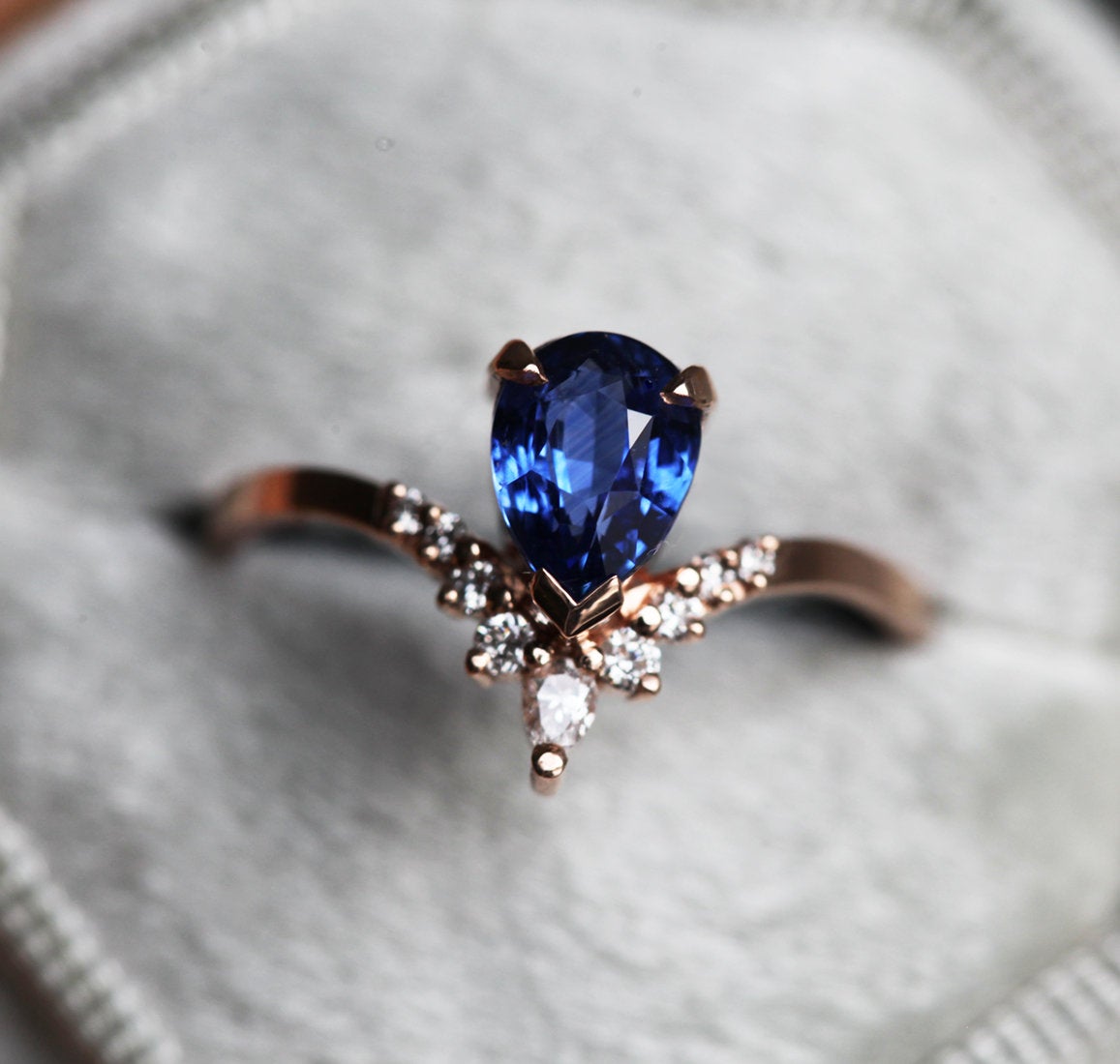 Pear-shaped blue sapphire ring with white diamonds