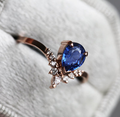 Pear-shaped blue sapphire ring with white diamonds