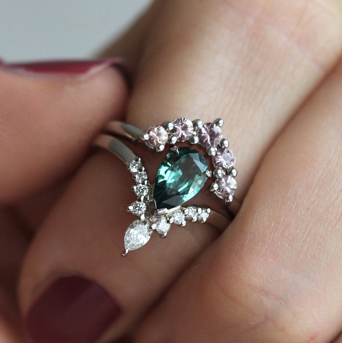 Pear-shaped teal sapphire prong ring with white diamonds