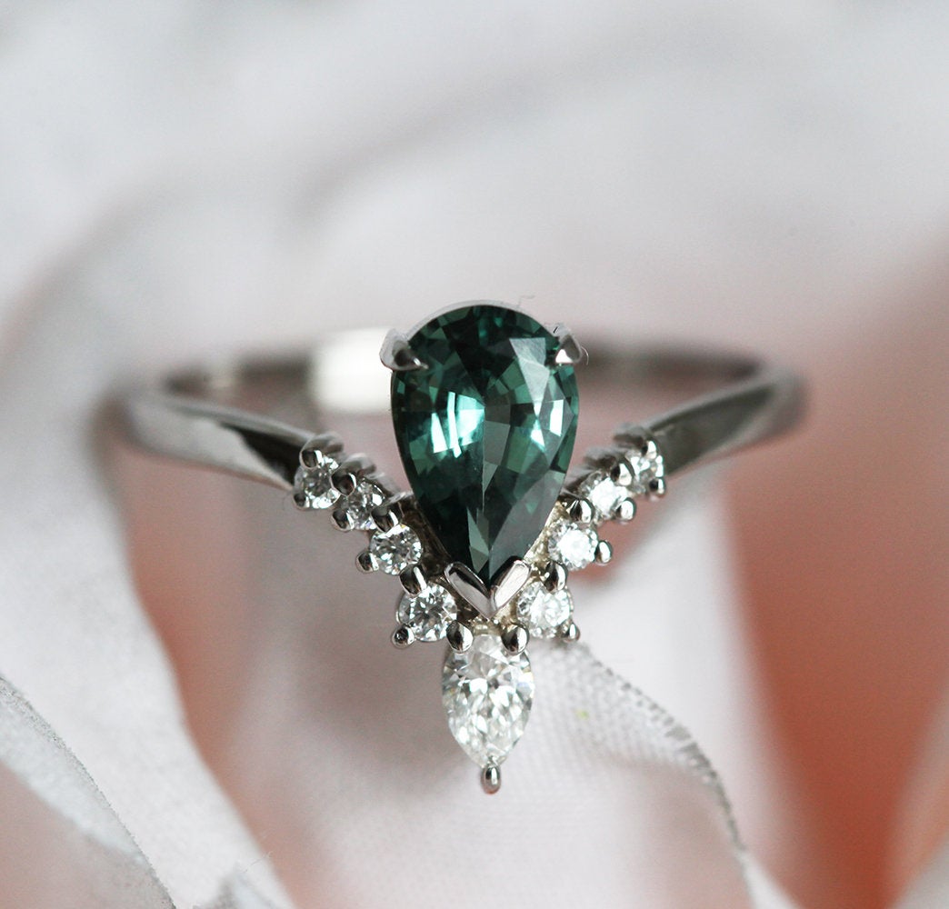 Pear-shaped teal sapphire prong ring with white diamonds