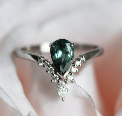 Pear-shaped teal sapphire prong ring with white diamonds