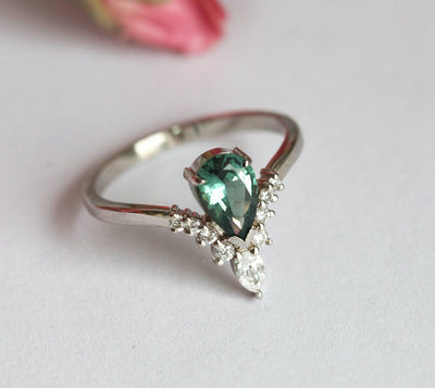 Pear-shaped teal sapphire prong ring with white diamonds